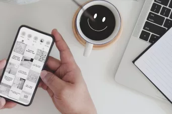 picture of hands holding a mobile phone showing a social media page