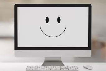 picture of a computer screen with a smiley face on the screen